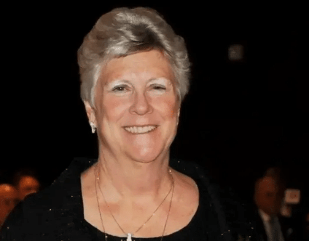 Leslie Moore, smiling, at a formal evening event.